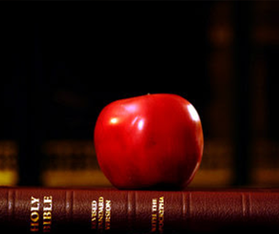 Bible with an apple sitting on top signifying Christian education